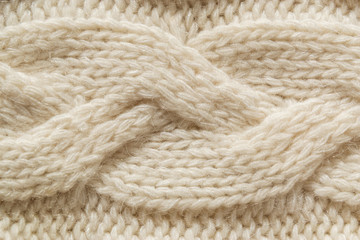 The closeup texture of cashmere things. Macro shot of knitted fabric from Lana Wool threads. Warm winter clothes. Background textile surface with copy space for text.