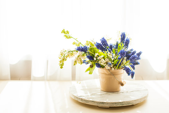 Bunch of grape hyacinths in a ceramic vase