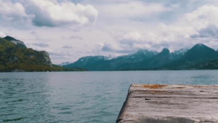 Wooden Pier on the Background of a Mountain Lake and Snowy Alps. Austria. Wolfgangsee Lake