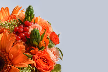 A flower autumn colors with autumn red berries of viburnum,orange gerbera,berries of eucalyptus, orange Ornithogalum, orange bouquet roses of the Alegria variety,cream bush rose of the Jana.Copy space