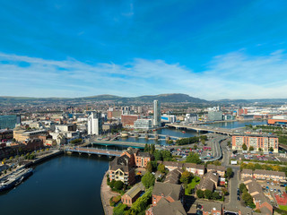 Fototapeta premium Aerial view on river and buildings in City center of Belfast Northern Ireland. Drone photo, high angle view of town 