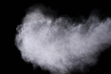 White powder explosion isolated on black background 