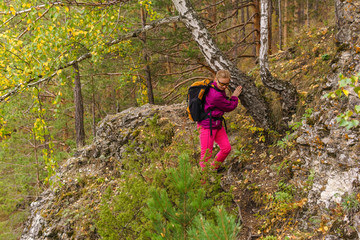 Fototapeta premium female hiker trekking in the autumn forest