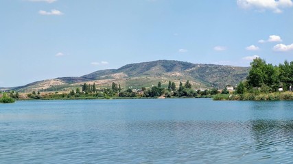 Fototapeta na wymiar Artificial lake surrounded by bushes