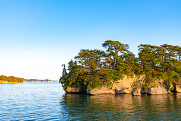 Obraz premium Matsushima Bay in dusk, beautiful islands covered with pine trees and rocks. One of the Three Views of Japan, and is also the site of the Zuigan-ji, Entsu-in and Kanrantei. in Miyagi Prefecture, Japan