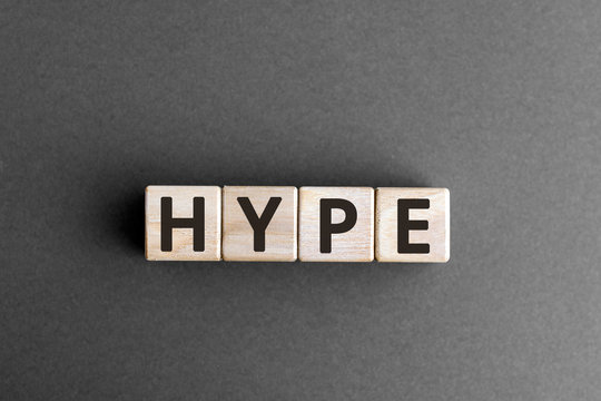 Hype - wooden blocks with letters, make people excited media hype concept,  top view on grey background
