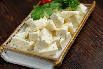 Cheese platter on a dark background. Food styling. Restaurant menu
