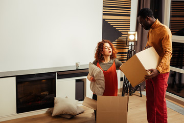 Concentrated young woman checking capacity of box