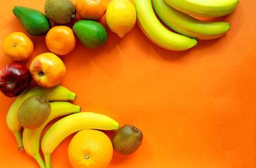 Frame of fresh fruits with space for text on orange background. Copy space. Harvest festival. Happy Thanksgiving day background. Fruits assortment