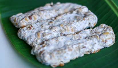 Black oncom on banana leaf background. Oncom is one of the traditional staple foods of West Javan (Sundanese) cuisine of Indonesia. 