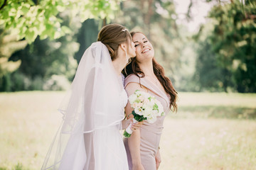 The bride kisses a bridesmaid