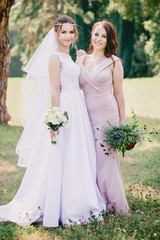 Bride and bridesmaid with bouquets