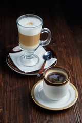 Cappuccino on a brown wooden background. Menu