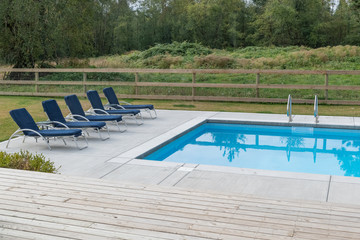 Suburban square swimming pool shot on a cloudy day