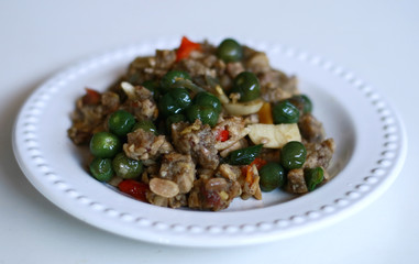 Sauteed oncom and black nightshade on white background. 