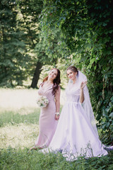 Bride and bridesmaid on a green background
