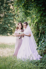 Bride and bridesmaid with a bouquet