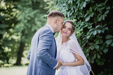 The groom kisses the bride