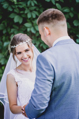 Happy couple on a background of greenery, close-up portrait