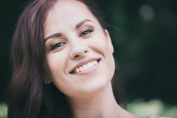Fototapeta premium brunette with a charming white-toothed smile