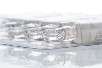 transparent ampoules for injection with medicine in package on a white background