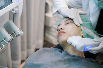 Laser or frequency Skin Tightening Face Lift treatment procedure involves.Young woman receiving...