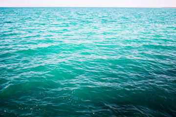 Shining blue water ripple background. Tropical backdrop.