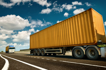 Yellow truck and container is on highway - business, commercial, cargo transportation concept, clear and blank space on the side view