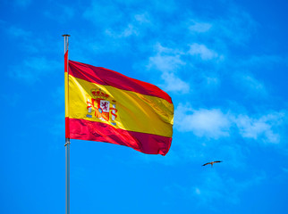National Spanish flag in blue sky with clouds Spain