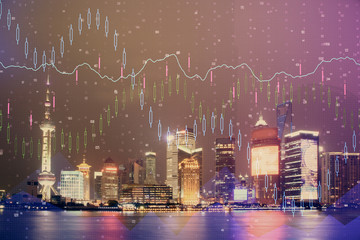 Financial graph on night city scape with tall buildings background double exposure. Analysis concept.