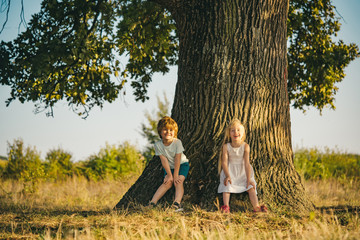 Childhood on countryside. Happy little farmers having fun on field. Ecology concept child. Eco...