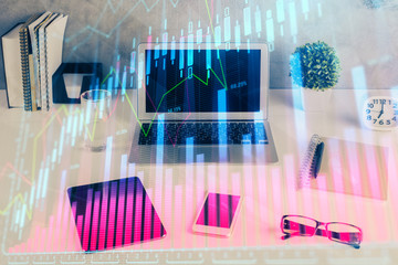 Financial chart drawing and table with computer on background. Multi exposure. Concept of international markets.