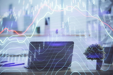 Stock market graph on background with desk and personal computer. Multi exposure. Concept of financial analysis.