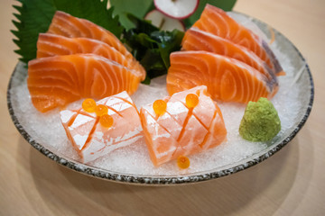 Fresh salmon slice sashimi serve on ice with wasabi Japanese style