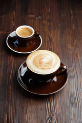 Cappuccino on a brown wooden background. Menu