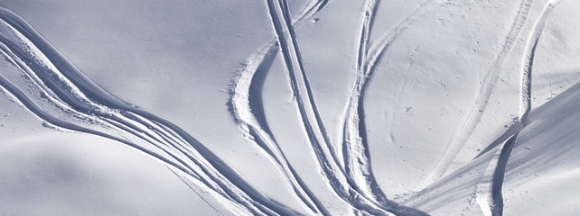 Off-piste slope with track from ski and snowboard on sunny evening