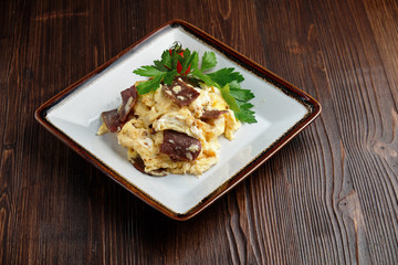 Omelet with meat on a white plate . catering menu