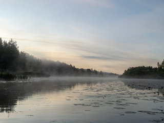 Beautiful morning fog on the lake. Forest, lake,  in the fog. Mysterious fog