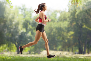 Young female athlete jogging outdoors