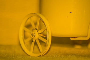 A yellow wheel infront of a yellow background