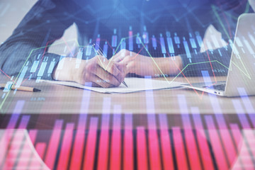 Double exposure hands with stock market chart.