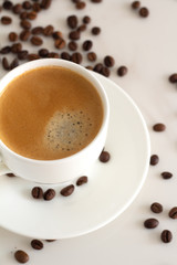 cup of coffee with beans on white 