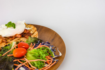 Homemade meal, Organic egg benedict with fresh salad on wood plate for healthy breakfast in white background