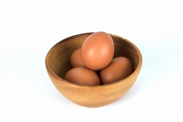 Fresh organic brown eggs in wood bowl isolated in white background with clipping path