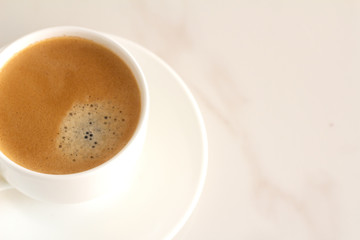 white cup with black coffee and place for text