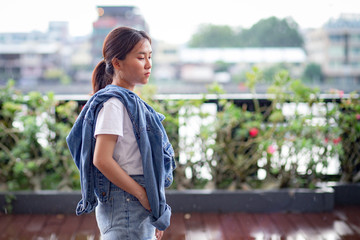 Portrait of Hipster Asian woman in white t-shirt, jean jacket and jeans