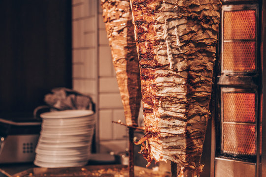 Doner kebab - dish in Middle Eastern cuisine. Roasted meat for shawarma in the street cafe or restaurant.