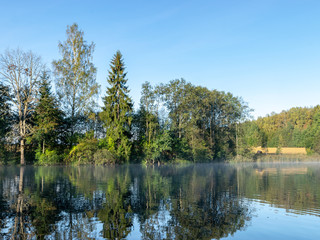 Fototapeta na wymiar beautiful landscape with lake, early morning, lake fog, morning sun colored trees