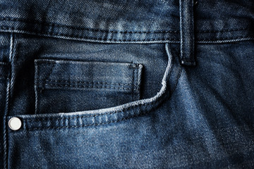 Small fifth pocket on gray jeans close-up. Denim, fashion concept. Place for text.