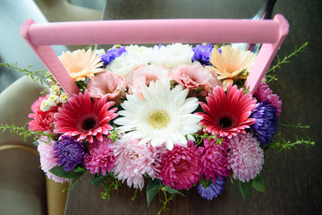 beautiful bouquet of bright wildflowers in basket,